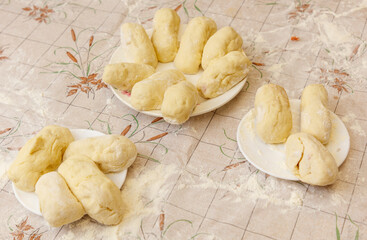 Three plates of doughnuts are on a table