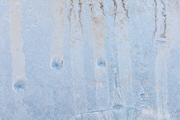 Frozen water drops on glass as an abstract background.
