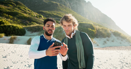 Outdoor, smartphone and men with exercise, internet and online reading with communication. People, fitness and friends with cellphone, network and sand with social media and app to track progress
