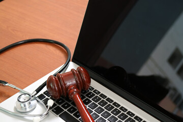 Medical Law Concept with Gavel and Stethoscope on Laptop