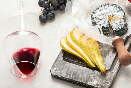 Bottle and glasses of red wine with snacks. Party concept. - Powered by Adobe