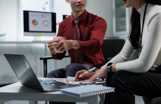 Business colleagues collaborating on project details in office - Powered by Adobe