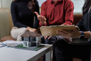 Real estate agent discussing house purchase with couple