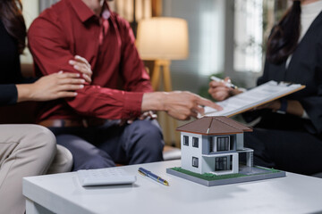 Couple discussing contract and home ownership with agent