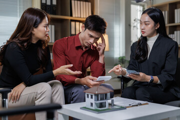 Couple discussing financial burdens with real estate agent