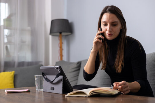 Woman working from home making phone call
