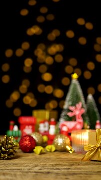 Christmas ornament items decoration on wooden table with copy space, for shopping promotion marketing during season greetings Merry Christmas with bokeh light at background, seamless looping