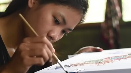 Young artist painting on canvas.