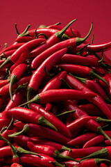 Pile of Vibrant Red Chili Peppers Close-up on Solid Background