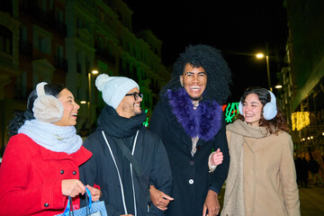 Group of friends walking and having fun at christmas market