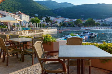 cozy outdoor cafe or restaurant located on embankment with panoramic view of Petrovac city,...