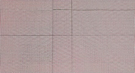 Detailed close up of a red and white checkered fabric pattern with intersecting lines and a textured surface