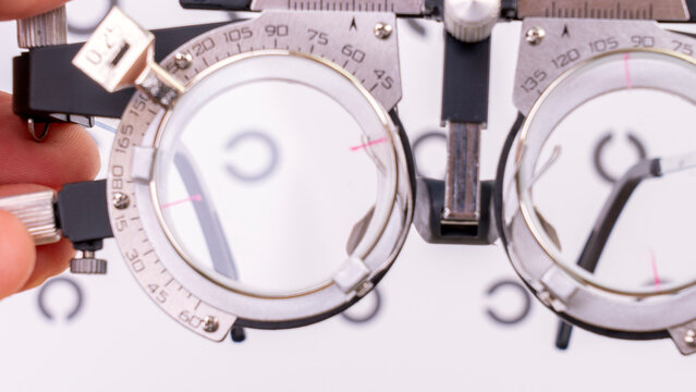 The trial frame stands out against a white, hazy backdrop. The ophthalmologist's instrument, the trial frame glasses, are used for the eye examination. High quality photo