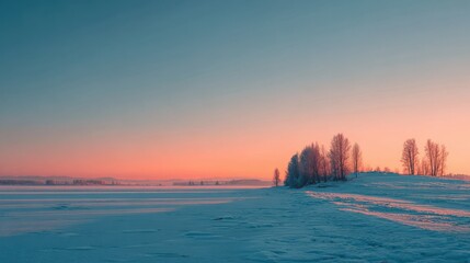 Snowy landscape with trees at sunrise over frozen lake and distant hills winter