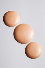 Beige foundation or primer texture swatch, minimal clean composition, glowing and smooth surface.