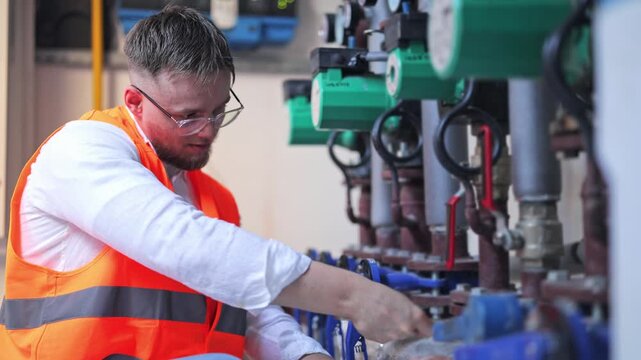 Focused professional meticulously inspecting complex industrial water pumps and piping. Diligent work ensures system efficiency. Dedicated concentration vital for technical task maintenance.