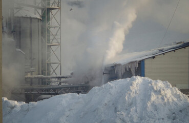 Smoke stacks from factory in winter sky. Industrial. Environmental pollution. Ust-Kamenogorsk (kazakhstan)