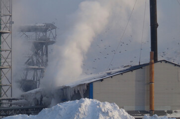 Smoke stacks from factory in winter sky. Industrial. Environmental pollution. Ust-Kamenogorsk (kazakhstan)
