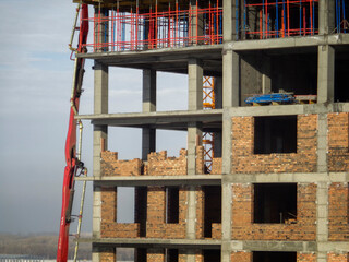 Apartment building under construction. Blue sky. Concrete frame. Workers. Floor pouring. Ust-Kamenogorsk (kazakhstan)