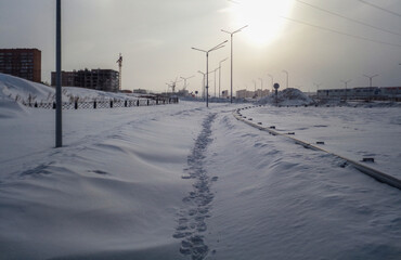 One of the city streets. Snow covered sidewalk. Grunge cityscape. Ust-Kamenogorsk (kazakhstan)