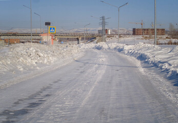 One of the city streets. Snowy road. City outskirts. Ust-Kamenogorsk (kazakhstan)