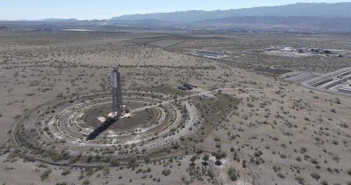 Aerial drone shot in the Tabernas desert facing the Plataforma Solar de Almer&iacute;a, Solar Platform of Almeria, solar farm, with Heliostat and solar panels. Shot in ProRes 422 HQ