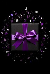 Above photo of black giftbox with purple ribbon wrapped as bow confetti and glitter around isolated on the black background