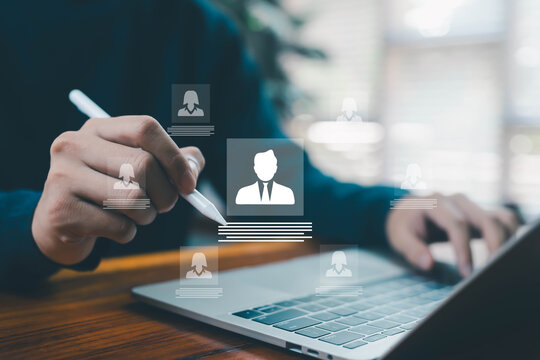 A hand using a digital pen to select a floating user profile icon on a laptop represents recruitment, HR management, candidate selection, talent acquisition, and modern digital hiring processes. - Powered by Adobe