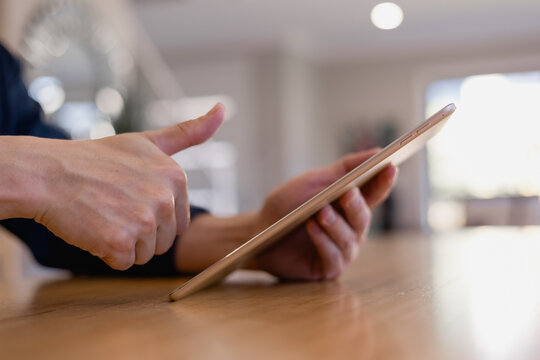 person using biometric fingerprint scan on a tablet with futuristic digital interface, representing data protection, identity verification, cybersecurity secure mobile access technology.