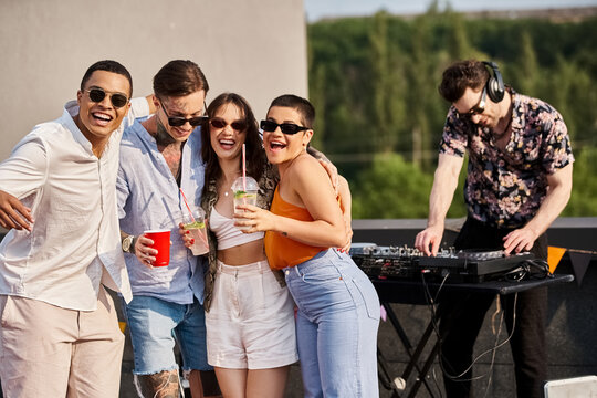 Young friends celebrate joyfully during a vibrant rooftop party under the sun