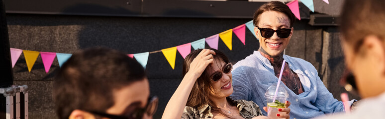 Obraz premium Young friends enjoy a vibrant rooftop party under the sun with laughter and joy