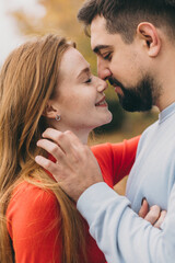 closeknit pair displaying warmth and affection, couple sharing loving gaze in autumn setting