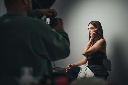 stylish portrait with dramatic light, model posing in cinematic atmosphere with minimal props and lighting