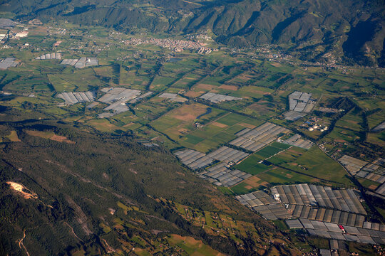 greenhouses near bogota aerial view from airplane window at sunset