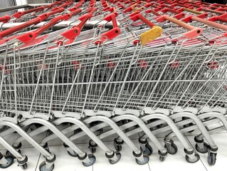 Rows of empty shopping baskets neatly arranged in the supermarket 