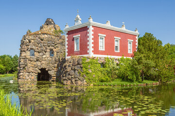 The stone island with the Villa Hamilton in Worlitz Park, in the middle of an English landscape garden