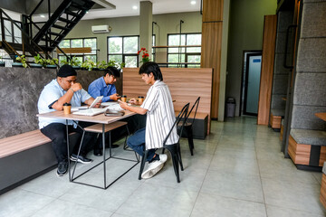 Engaging Young Entrepreneurs Collaborate On Project In Modern Co-Working Space