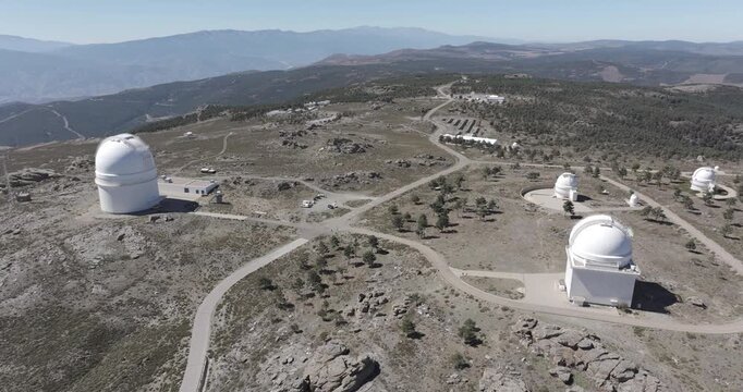 Aerial drone shot towards Calar Alto Observatory telescopes in the Sierra de Los Filabres mountain range in Almeria, Andalusia, Spain. Largest astronomical observatory in Europe. Shot in ProRes 422 HQ