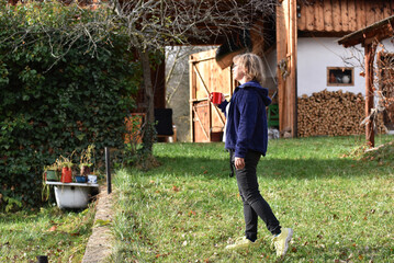 Woman enjoys a warm drink in a rustic backyard