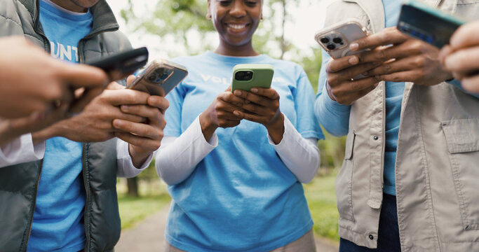 Phone, volunteer and solidarity with hands of people in nature for community service chat, team and eco ngo app. Environment fundraising, tech and social media with low angle of friends outdoor