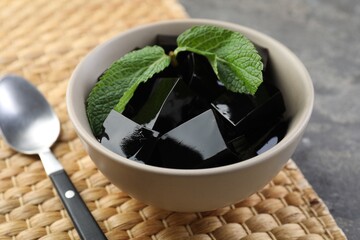 Tasty herbal jelly with mint served on grey table, closeup