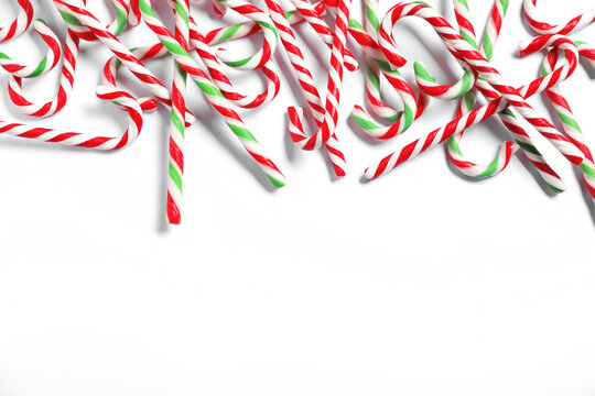 Tasty candy canes on light background, flat lay with space for text. Christmas treat - Powered by Adobe
