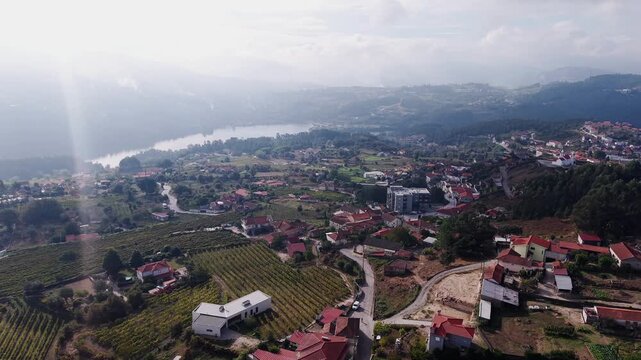 Aerial zoom out of rio de moinhos village with the t&acirc;mega river behind