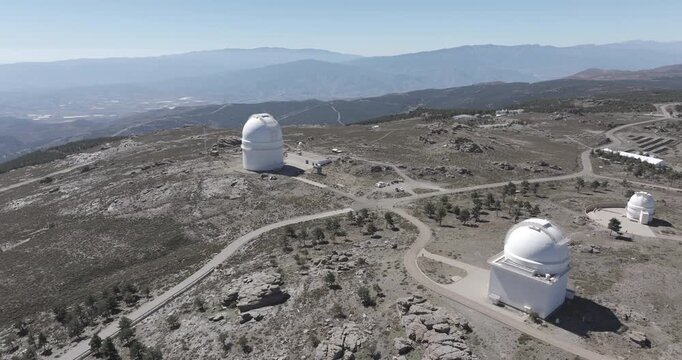Aerial drone shot towards Calar Alto Observatory telescopes in the Sierra de Los Filabres mountain range in Almeria, Andalusia, Spain. Largest astronomical observatory in Europe. Shot in ProRes 422 HQ