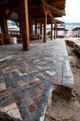 Ancient mosaic walkway with intricate stone patterns outdoors.