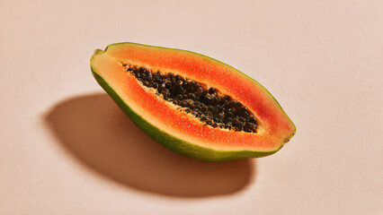 Single papaya slice centered on pastel cream background with generous negative space and minimal mood
