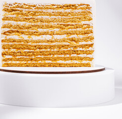 Delicious layered cake displayed on a white stand in a bright setting