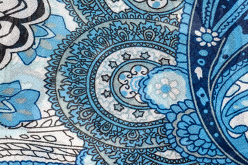 Intricate blue paisley pattern on fabric, a detailed textile design