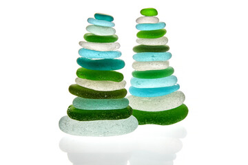 Sea polished glass shards arranged in a pyramid isolated on white background.