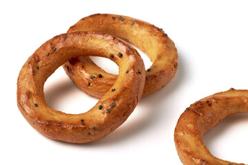 Salted pretzels with poppy seeds isolated on a white background.